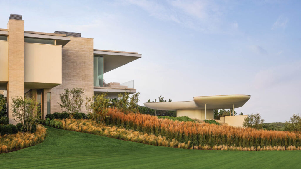 the landscaped exterior of a mid century modern beach house