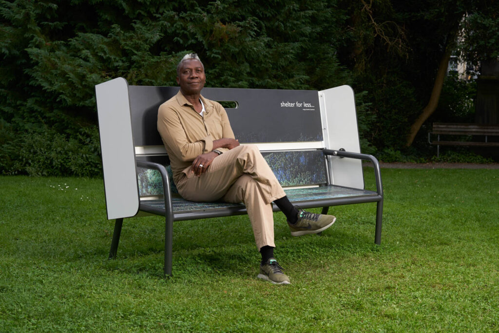 Charles O. Job sitting atop Bench Bed, a bench that transforms into a bed designed by Job for Design Biennale Zürich 2021.