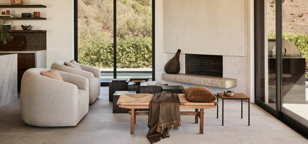 a living room with a fireplace and large windows