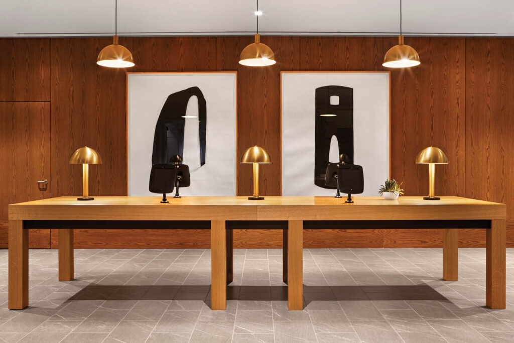 Oak and burnished-brass fixtures warming the lobby of the redesigned Ridge Hotel