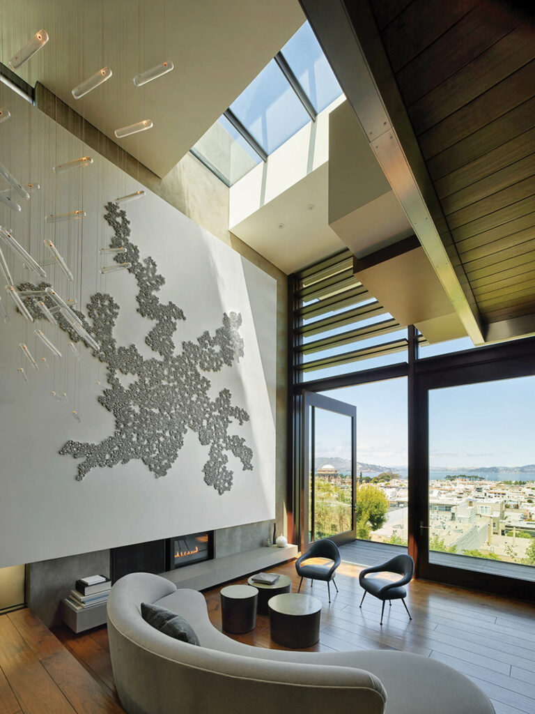 a cream curved couch in a living room with floor-to-ceiling windows