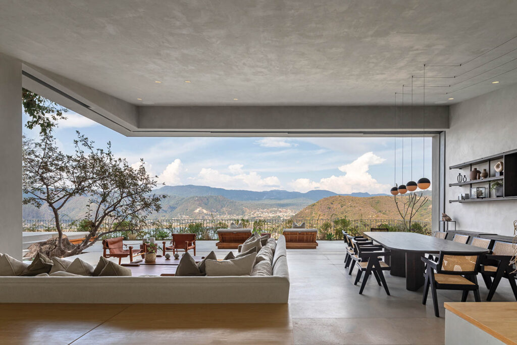 an indoor outdoor living area overlooking mountains