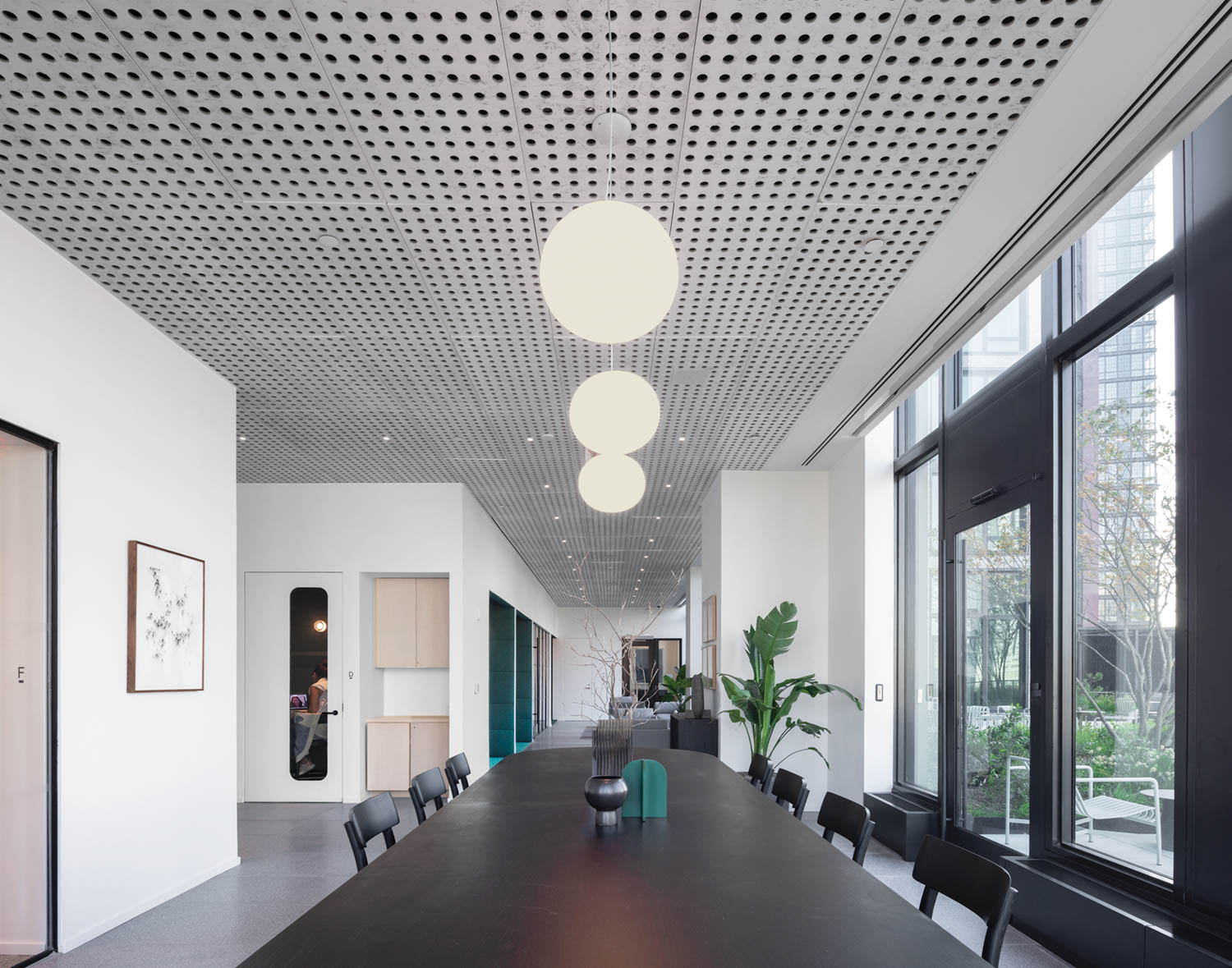 globular pendant lights above a conference table in a residential building