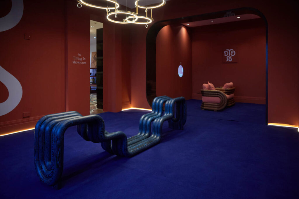 a wavy brash bench in a blue-hued room