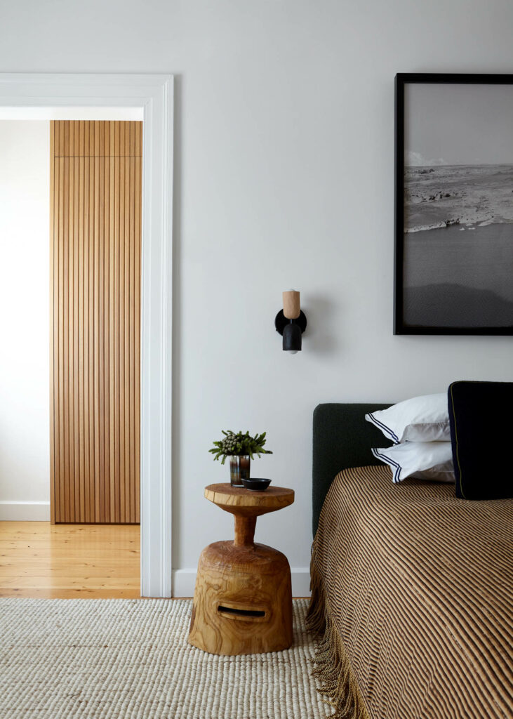 a primary bedroom with earth tones and bohemian furnishings