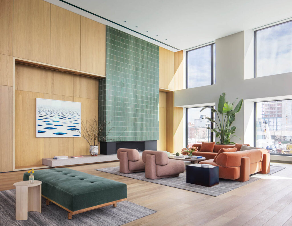 a great room with muted furniture and a ceramic tile fireplace mantel