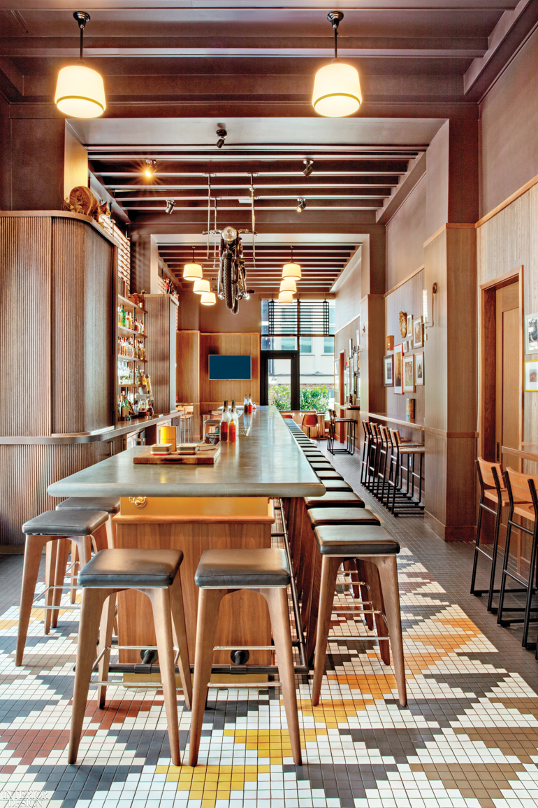 The bar in the Perry Lane Hotel features a tiled floor in colorful patterns and a stools for patrons