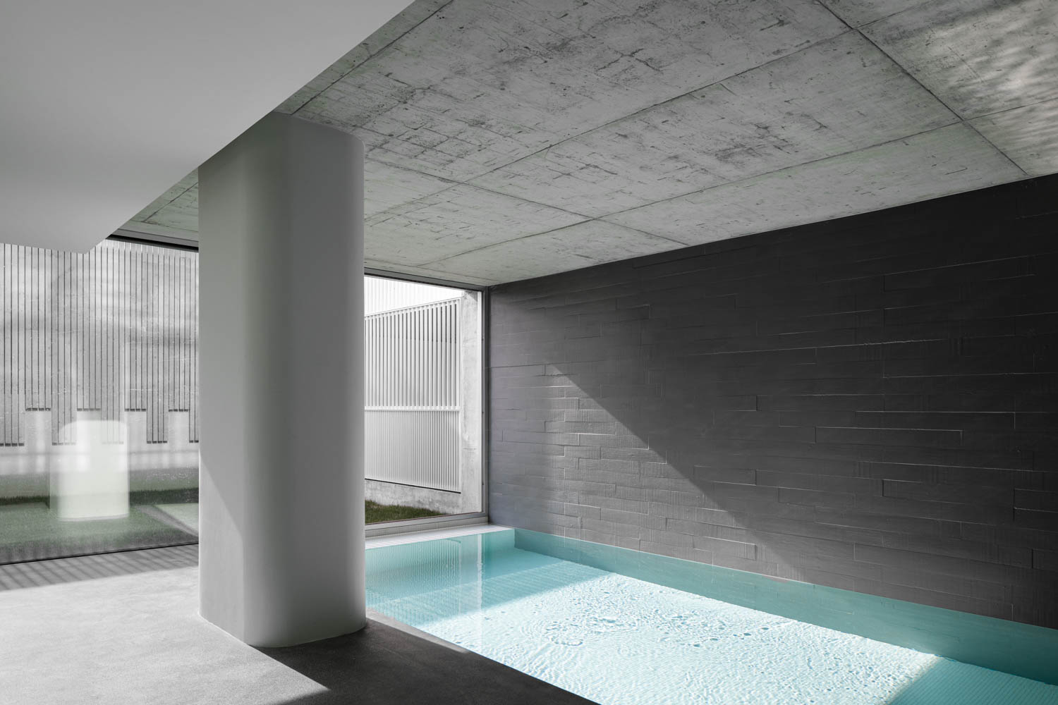 a heated indoor pool in a Brutalist apartment building