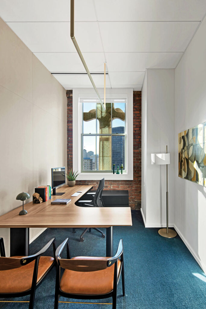 office space with blue carpeted flooring and orange chairs