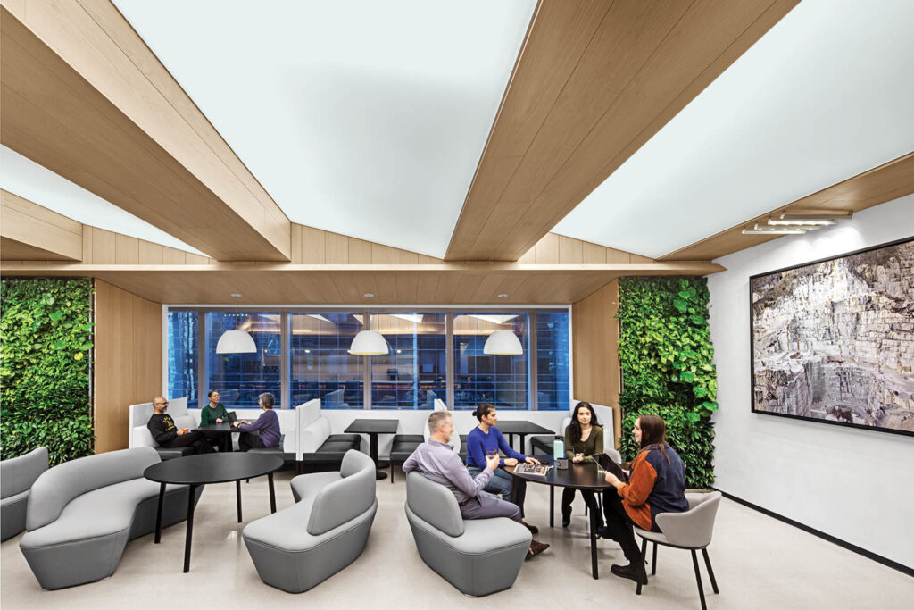 employees in a common area with gray chairs