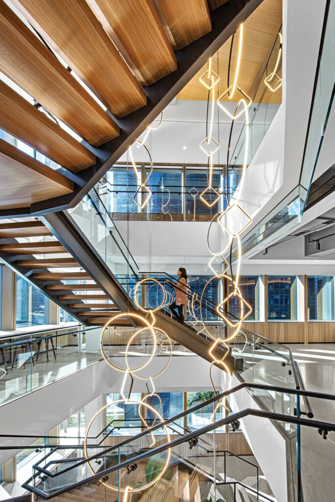 an installation of circular lights in an open staircase