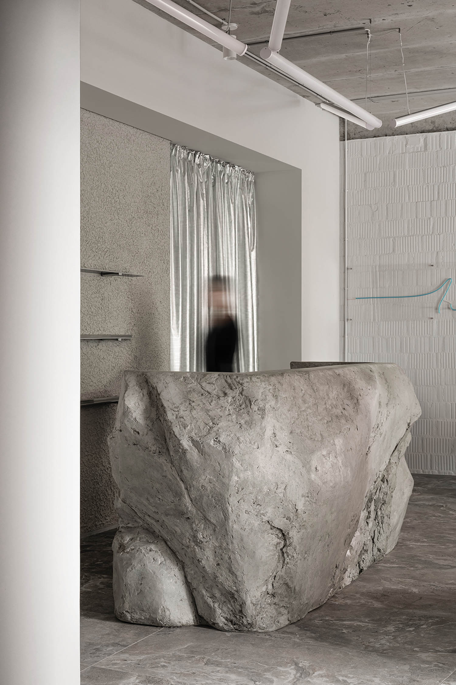 hallway with large rock and grey undertones