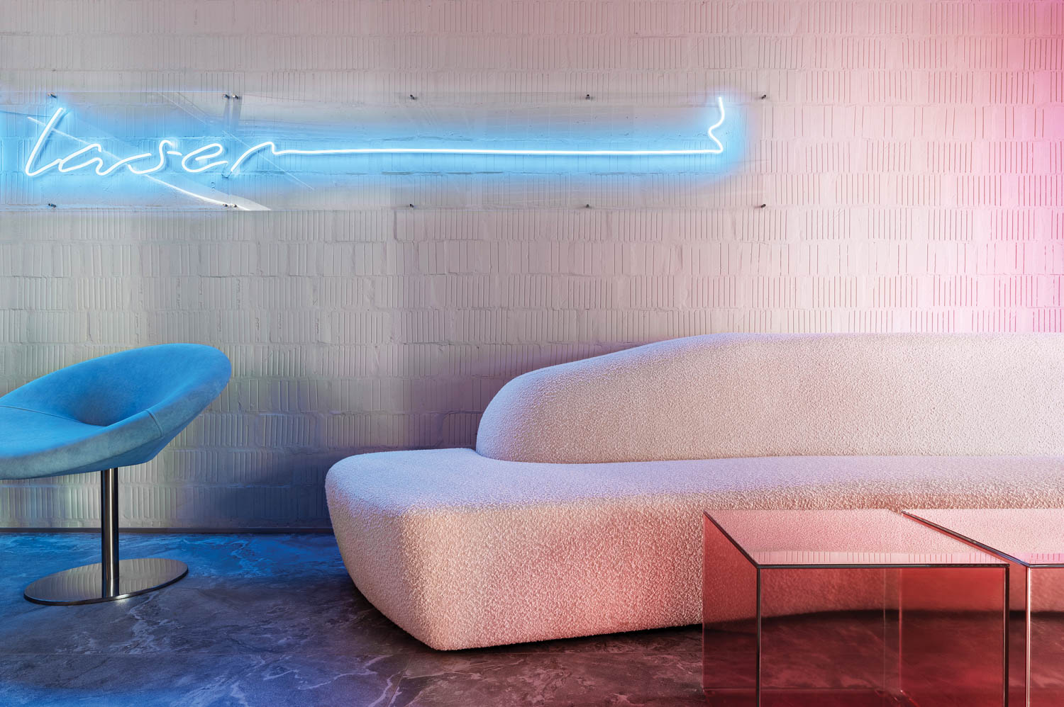 waiting room with pink couches and neon lighting