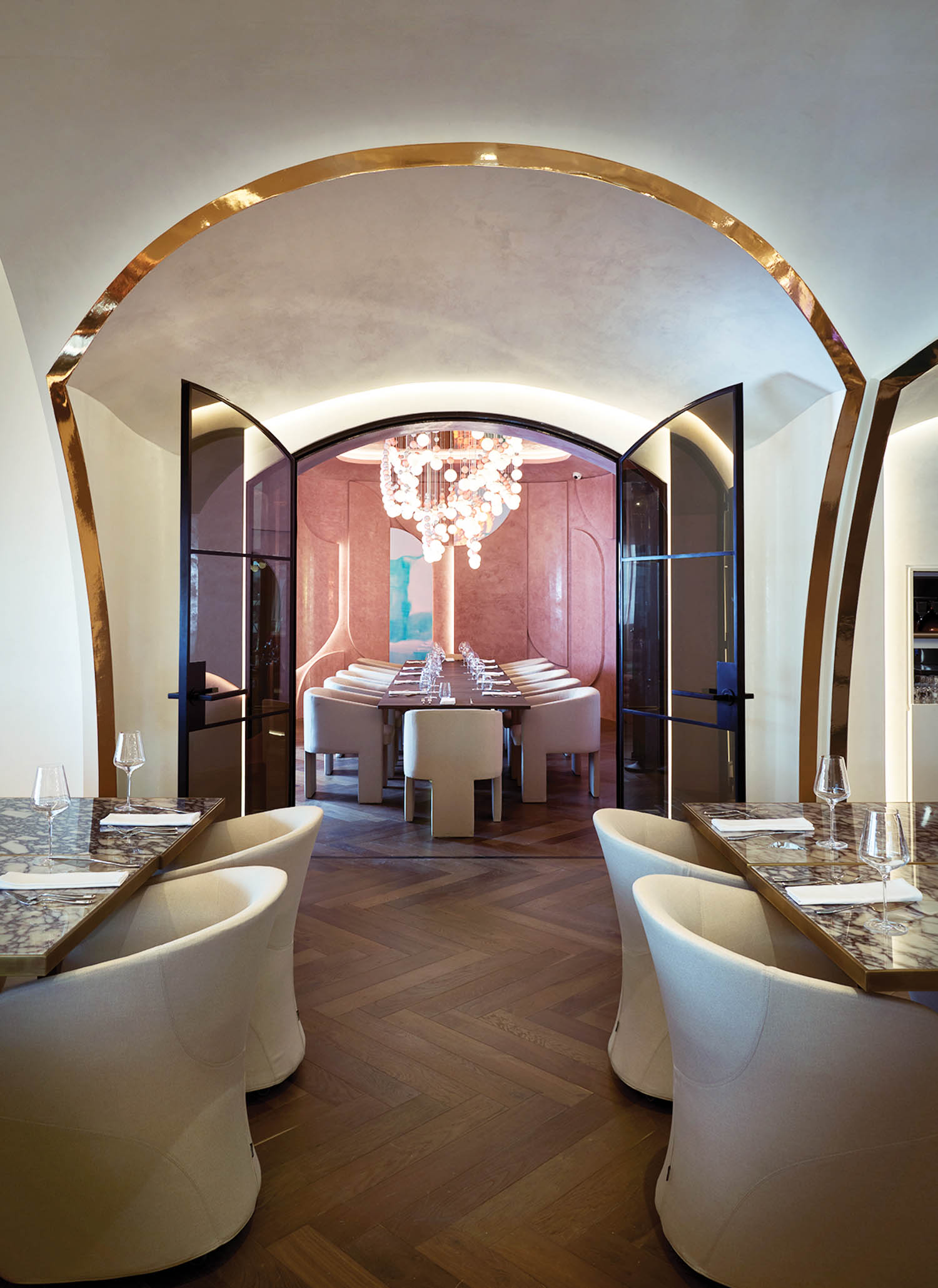 dining area with arched entryways and curved white chairs