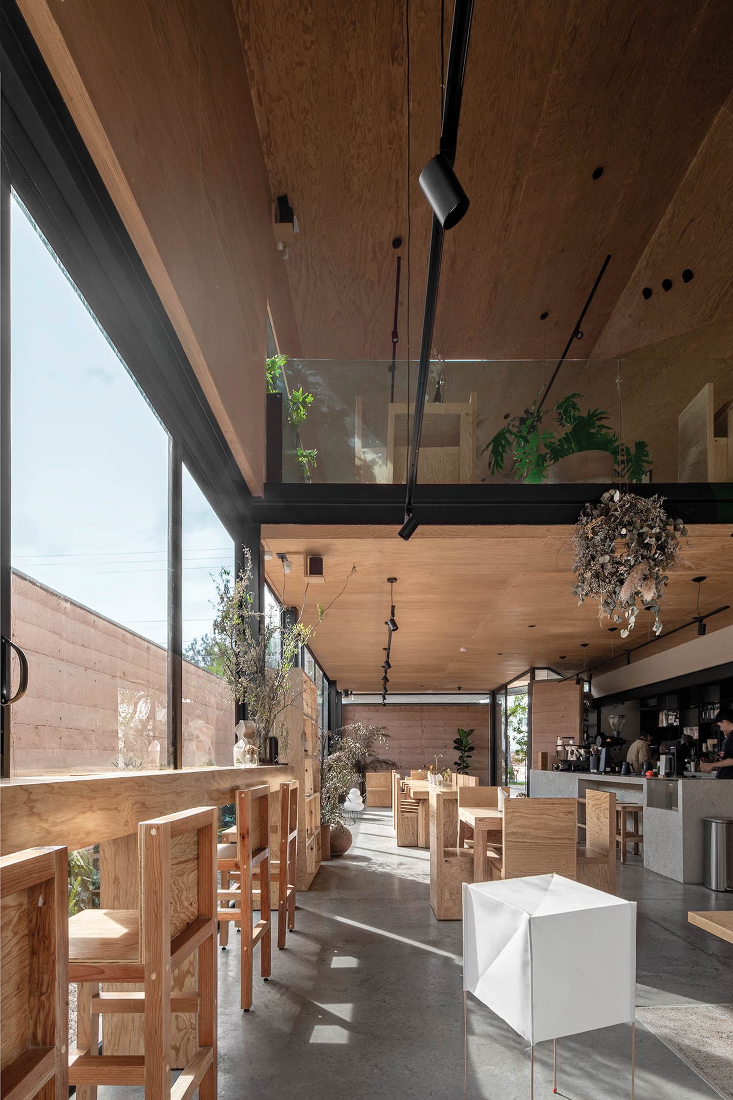 empty dining space with wooden tables and white box