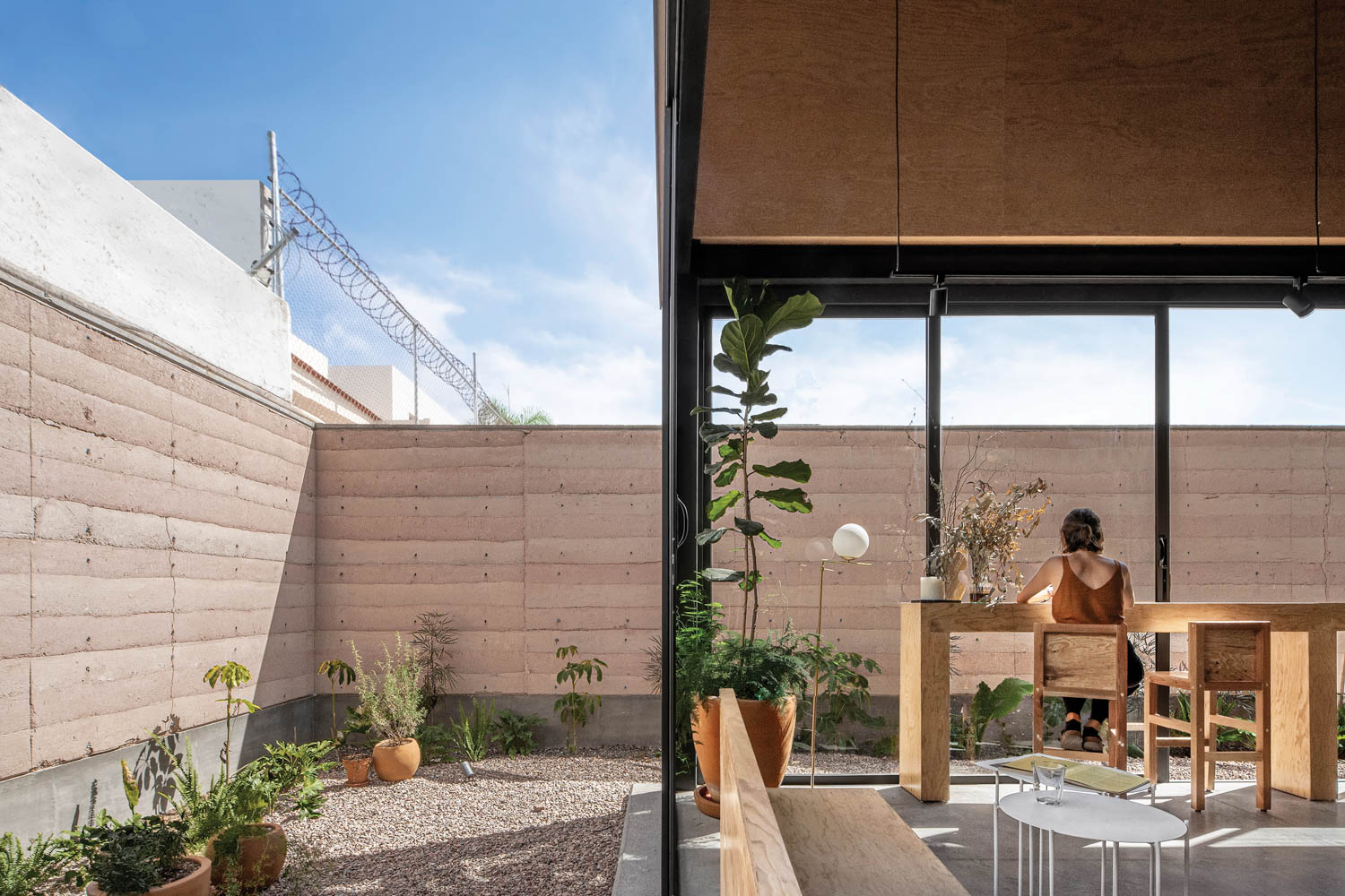 outdoor courtyard dining area with wooden tables and cover