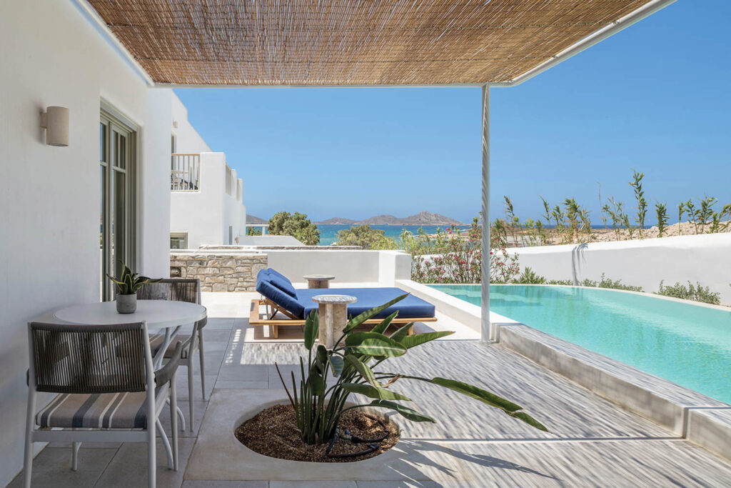 pool area with view of the surroundings and bright blue sunchair