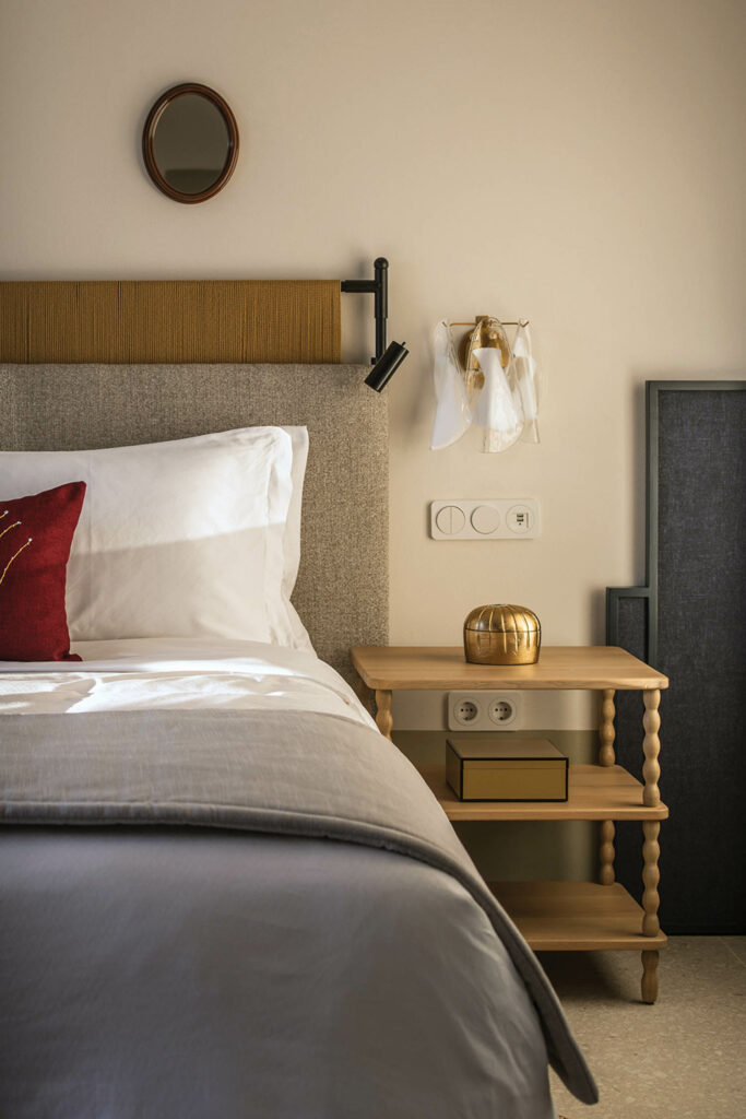 bedroom with basic wooden side console and gray headboard