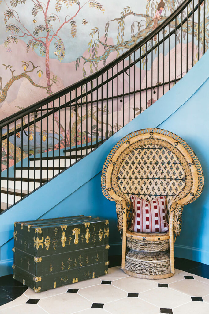 entrance of a home with a trunk and a curved staircase