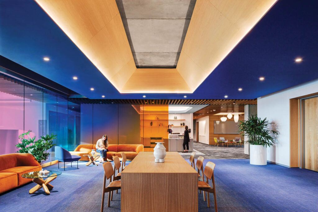 dark blue break room with wooden desks and bright lighting