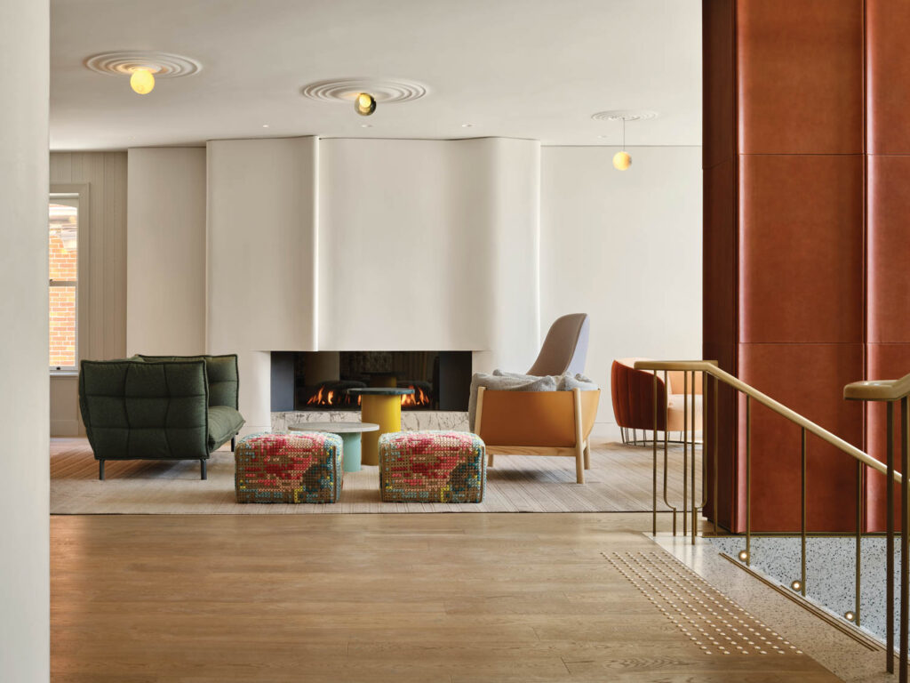 sitting area with multicolored chairs and tv